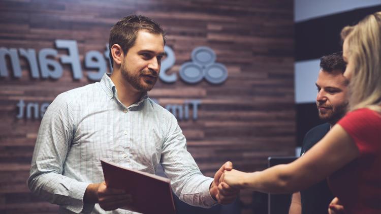 State Farm agent shaking hands with a woman.